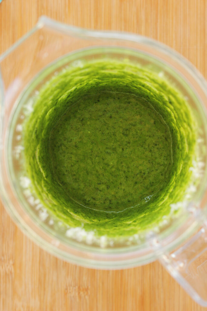 top down close up image of a blender filled with a bright green liquid