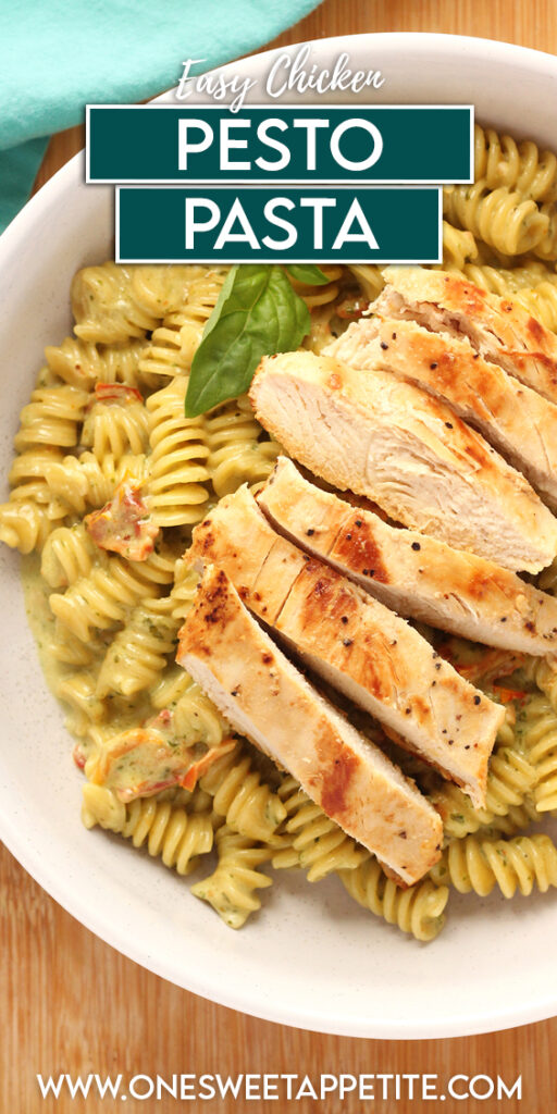 close up top down image showing a shallow white bowl filled with rotini pasta that is covered in a light green sauce with sun dried tomatoes sprinkled throughout. A sliced grilled chicken breast is sitting on top. Text overlay reads "easy chicken pesto pasta"