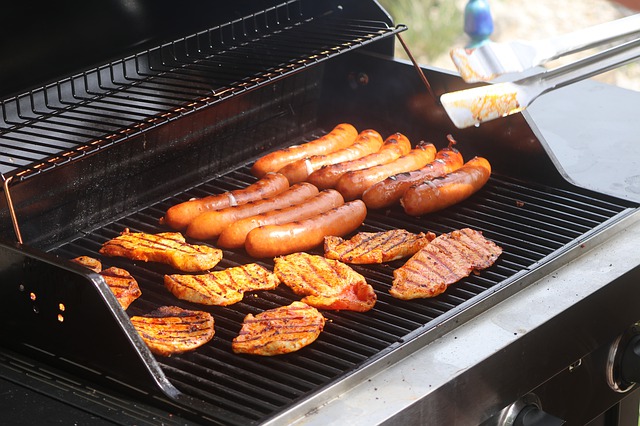 meat and sausage being grilled over a best propane grill