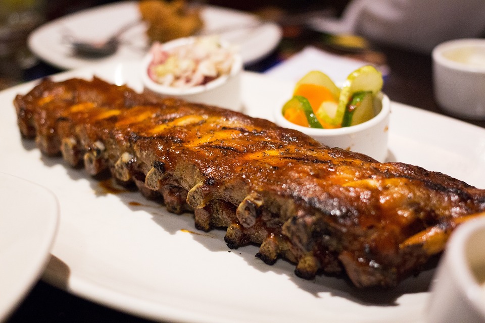 Grilled barbecue pork ribs in a white plate